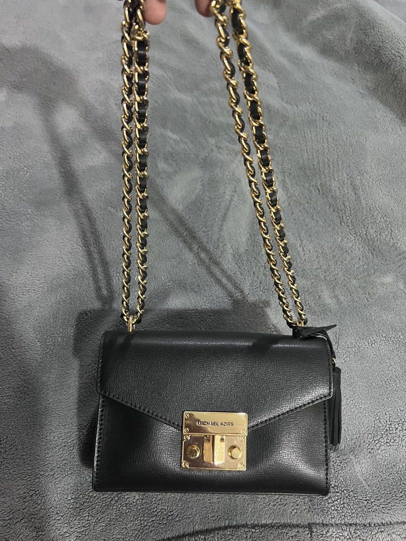 Michael Kors Black Leather Chain Shoulder Bag (Category: Shoulder Bags) located in Antipolo. Submitted by personal_picked_by_yanyan (Listing ID 1460203384, Image 1). Description: - Authentic Michael Kors black leather shoulder bag - Elegant gold chain strap - Stylish side tassel detail - Secure lock closure featuring the Michael Kors logo - Ideal for evening events or elevating any outfit - Compact size, perfect for carrying essentials.