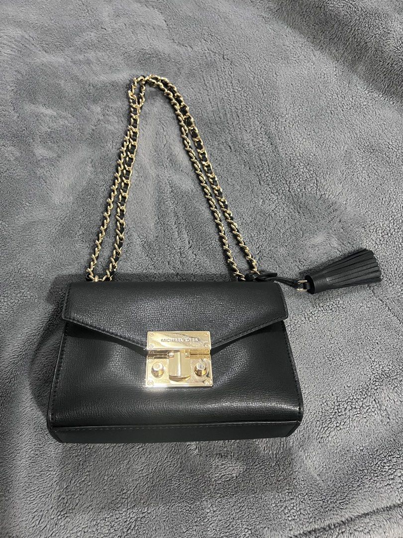 Michael Kors Black Leather Chain Shoulder Bag (Category: Shoulder Bags) located in Antipolo. Submitted by personal_picked_by_yanyan (Listing ID 1460203384, Image 2). Description: - Authentic Michael Kors black leather shoulder bag - Elegant gold chain strap - Stylish side tassel detail - Secure lock closure featuring the Michael Kors logo - Ideal for evening events or elevating any outfit - Compact size, perfect for carrying essentials.