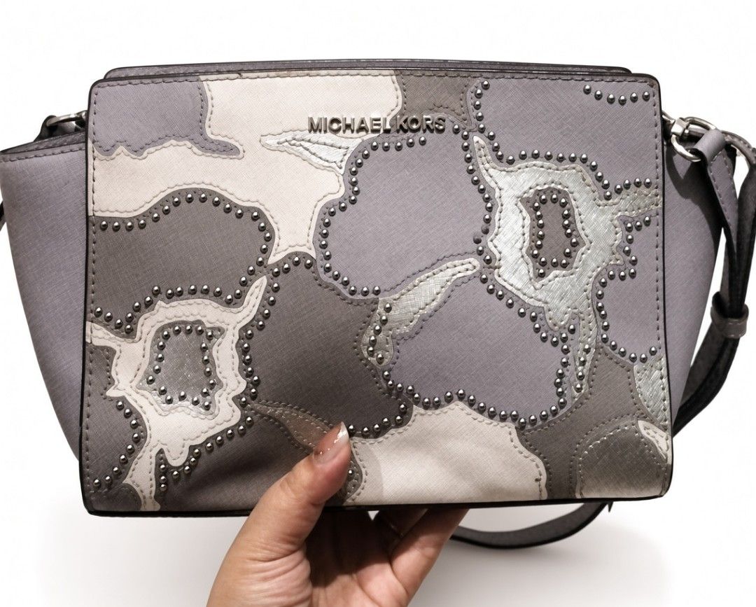 Michael Kors Grey Studded Shoulder Bag (Category: Shoulder Bags) located in Quezon City. Submitted by borresashl49573 (Listing ID 1460274130, Image 1). Description: - Grey Michael Kors shoulder bag♥️ - Unique patchwork design with silver studs 😍 - Interior lining features Michael Kors logo pattern - Secure zipper closure - Adjustable strap for comfort.