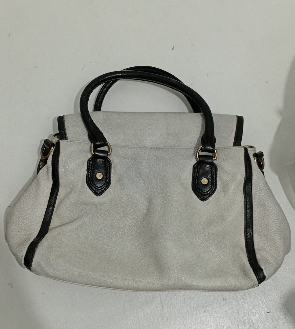Michael Kors Off White Leather Satchel Handbag (Category: Luxury Bags & Wallets) located in Manila. Submitted by eriiicaspage (Listing ID 1460187822, Image 3). Description: PreOwned WellUsed Authentic Mk White leather handbag with black trim and handles Medium - Iconic Michael Kors (MK) logo on the front - Interior lining with repeating MK pattern - Ample space for your essentials - A timeless Michael Kors design Sign of Used Condition sa Leather