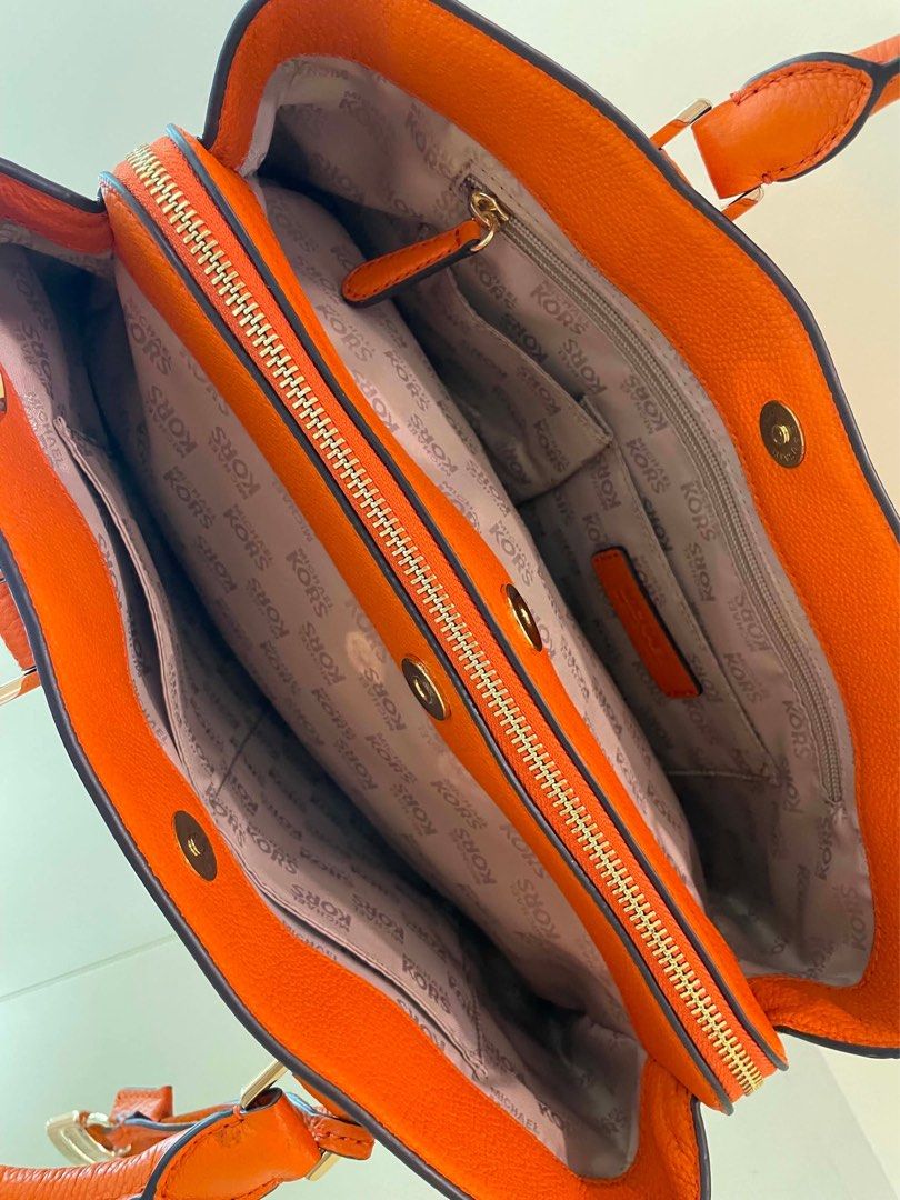Michael Kors Orange Leather Satchel Bag (Category: Luxury Bags & Wallets) located in Manila. Submitted by thevintagebow (Listing ID 1460198655, Image 2). Description: Pop of color: Michael Kors Orange Pebbled Leather Satchel! 🍊 Add a gorgeous burst of energy to your closet with this vibrant, structured satchel. Crafted from supple orange pebbled leather with sleek silver-tone hardware, a secure top-zip closure, and an elegant hanging padlock cha