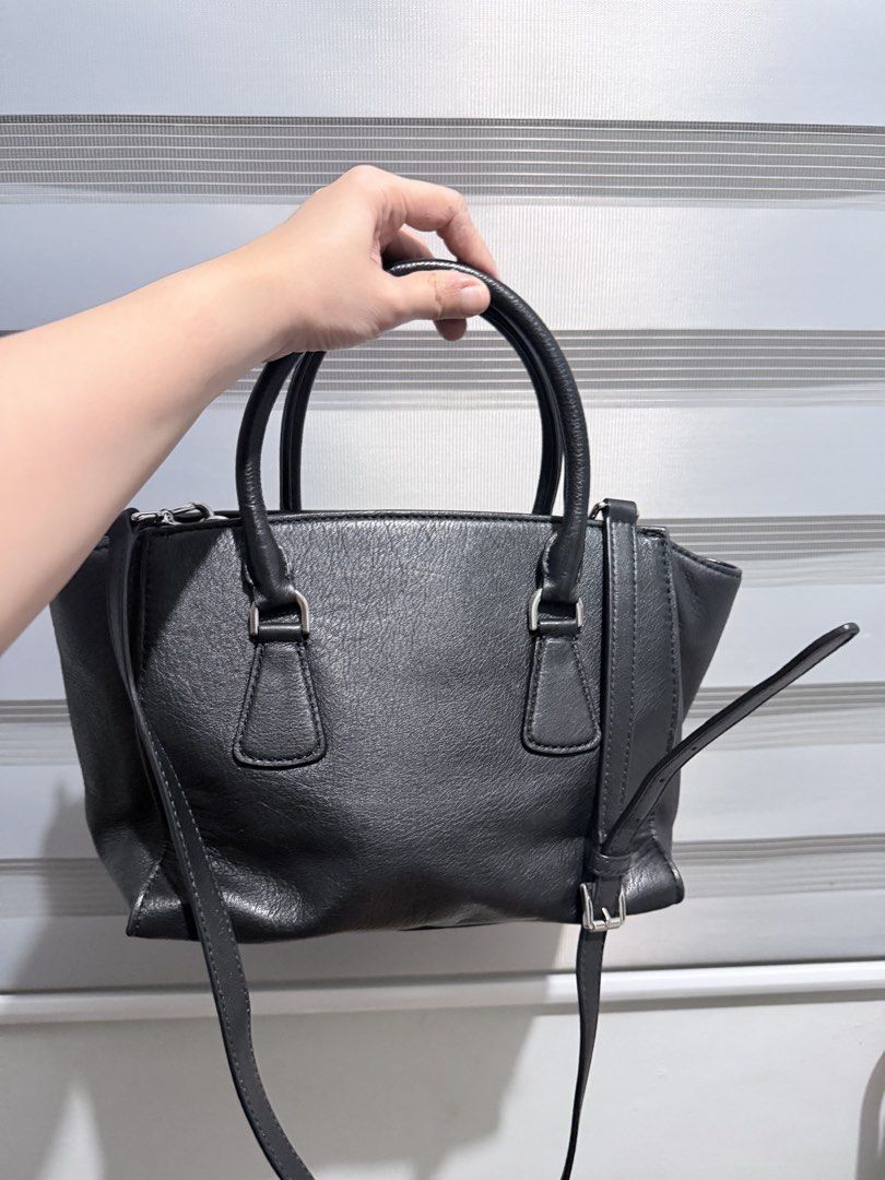 Michael Kors Sophie Satchel (Category: Cross-body Bags) located in Manila. Submitted by prelovedbygayle (Listing ID 1460276648, Image 2). Description: Silhouette & Build: Features a structural, slightly winged trapezoidal body crafted from durable smooth leather. Front Details: Outfitted with a signature functional horizontal front zipper pocket adorned with a vertical leather zip pull. Hardware & Branding: Finished with silver-tone hardware, inc