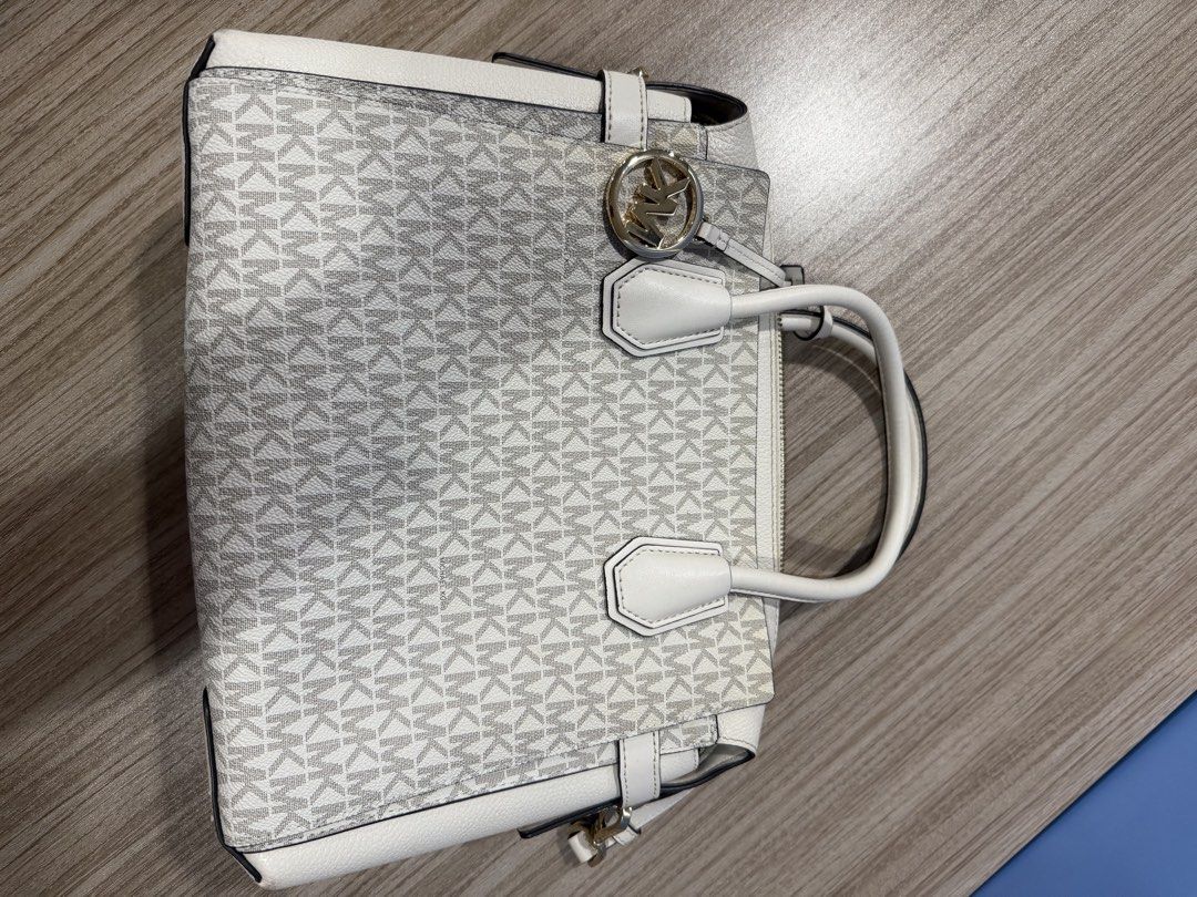 Michael Kors White Monogram Leather Satchel Handbag (Category: Luxury Bags & Wallets) located in Quezon City. Submitted by jdmc16 (Listing ID 1460246463, Image 2). Description: - Authentic White Michael Kors Satchel - Classic MK Monogram Print - Genuine Leather Trim and Handles - Elegant Gold Hardware Details - Secure Zipper Closure - Ample Interior Space - Ideal Everyday Bag.