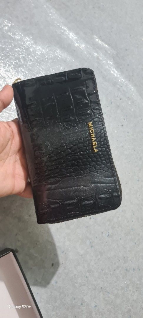 Michaela Black Croc Zip Around Wallet (Category: Wallets & Card holders) located in Pasig City. Submitted by kassandrac. (Listing ID 1460146457, Image 1). Description: - Brand: Michaela - Color: Black - Material: Textured croc effect - Closure: Zip around - Includes: Original box and thank you card - Features: Keeps cards and cash organized - Style: Simple and classic - receive as a gift- almost 599 sa mall and shoppee i sell it for only 500 .
