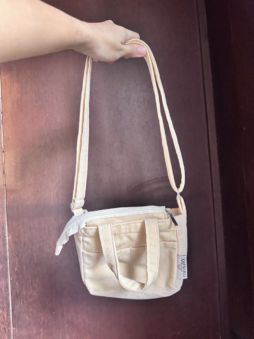 Micro Sling Bag - Cream (Category: Cross-body Bags) located in Makati City. Submitted by prelovednialice (Listing ID 1460158335, Image 2). Description: Cream micro-sling bag. Fits small wallet and phone. 8/10 condition - working zipper.