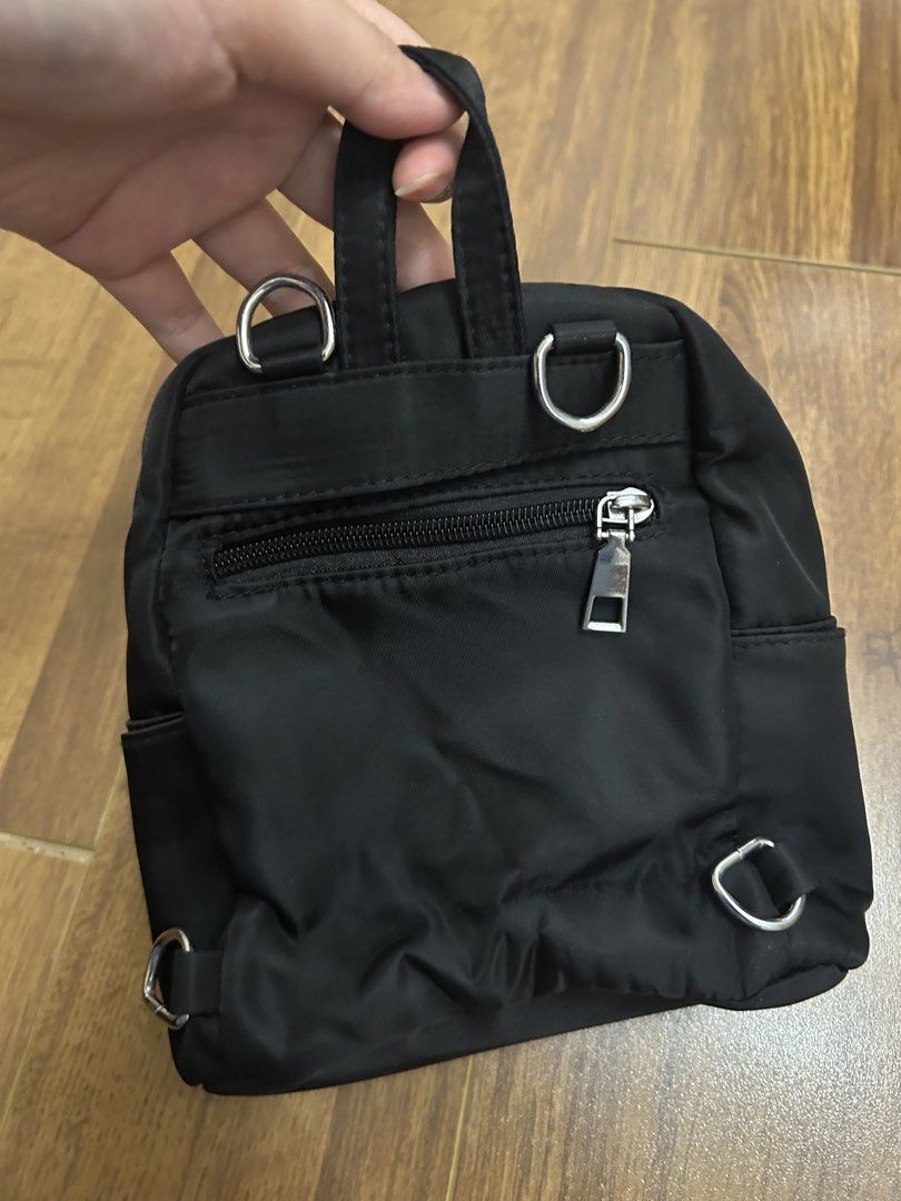 Mini Backpack (Category: Backpacks) located in Puchong. Submitted by luilica (Listing ID 1460285248, Image 3). Description: - Front zip pocket, inside got 1 zip & side compartment. - Both sides have pockets - Detachable strap (can use as backpack & slingbag - Size (cm): H-21, L-19, D-8 .