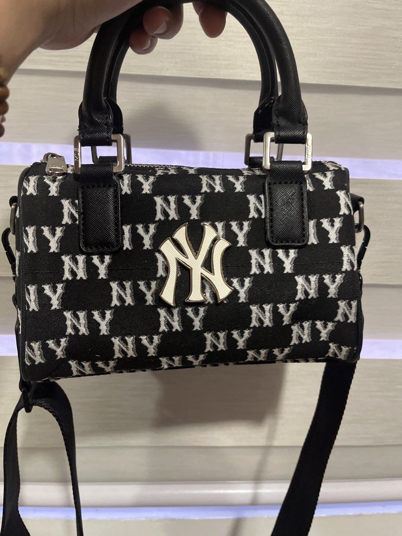 MLB New York Yankees Monogram Mini Boston Bag (Category: Cross-body Bags) located in Pasig City. Submitted by melaiski28 (Listing ID 1460152672, Image 1). Description: - Cute mini Boston bag (unused) - NY Yankees monogram print - Classic black and white design - Features top handles - Includes a detachable shoulder strap - Secure zipper closure - Comes with original MLB tag - Ideal for everyday use or quick outings With flaws ,color transfer/disc