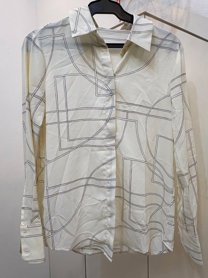 MNG by Mango Printed Long-Sleeve Blouse (Category: Others Tops) located in Paranaque City. Submitted by yanionlineshopping (Listing ID 1460234033, Image 1). Description: MNG by Mango Printed Long-Sleeve Blouse * Size XS / US 2 * White with elegant black geometric line print * Long sleeves with buttoned cuffs * Classic pointed collar and button-down front * Clean, sophisticated office-to-dinner style .