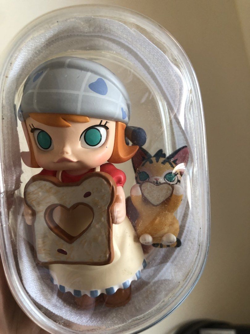 Molly Pop Mart Figure with Cat (Category: Designer & Blind Box Toys) located in Mandaluyong City. Submitted by chimbashey (Listing ID 1460150643, Image 2). Description: - Adorable Molly figure with her cat companion. - Features them holding toast with cute heart cutouts. - Comes in its original, clear packaging. - Ideal for collectors or as a thoughtful gift. - Adds a fun and charming touch to any display..