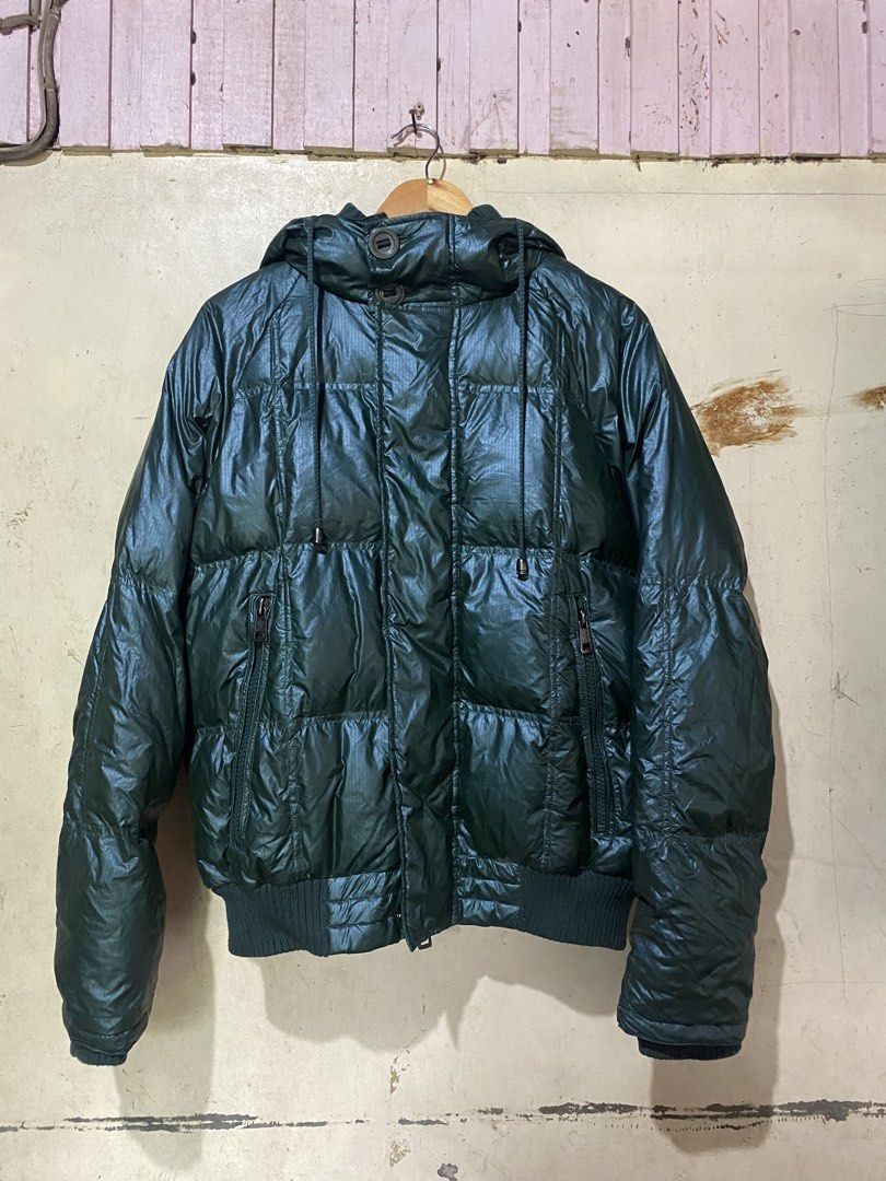Moncler Down Puffer Jacket Size 50 Green Hooded (Category: Coats, Jackets and Outerwear) located in Manaoag. Submitted by jericsapigao (Listing ID 1460260637, Image 1). Description: - Green Moncler puffer jacket - Size 50 - 100% down filling for ultimate warmth - 100% polyamide lining - Attached hood - Convenient zip pockets - Features unique comic strip care instructions inside - Ideal for cold weather conditions.