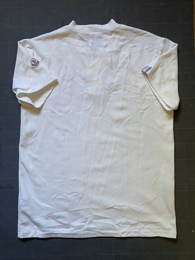 Moncler White Polo Shirt with Logo Patch (Category: Tshirts & Polo Shirts ) located in Zamboanga. Submitted by trippsnthrifts (Listing ID 1460256799, Image 2). Description: - Classic white Moncler polo shirt - Features iconic Moncler logo patch on sleeve - Buttonless placket with a classic collar - Comfortable and stylish design - Perfect for casual outings or as a layering piece.