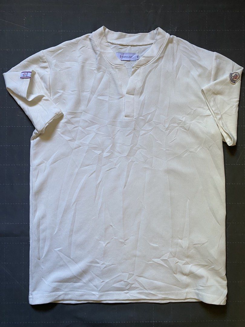 Moncler White Polo Shirt with Logo Patch (Category: Tshirts & Polo Shirts ) located in Zamboanga. Submitted by trippsnthrifts (Listing ID 1460256799, Image 1). Description: - Classic white Moncler polo shirt - Features iconic Moncler logo patch on sleeve - Buttonless placket with a classic collar - Comfortable and stylish design - Perfect for casual outings or as a layering piece.