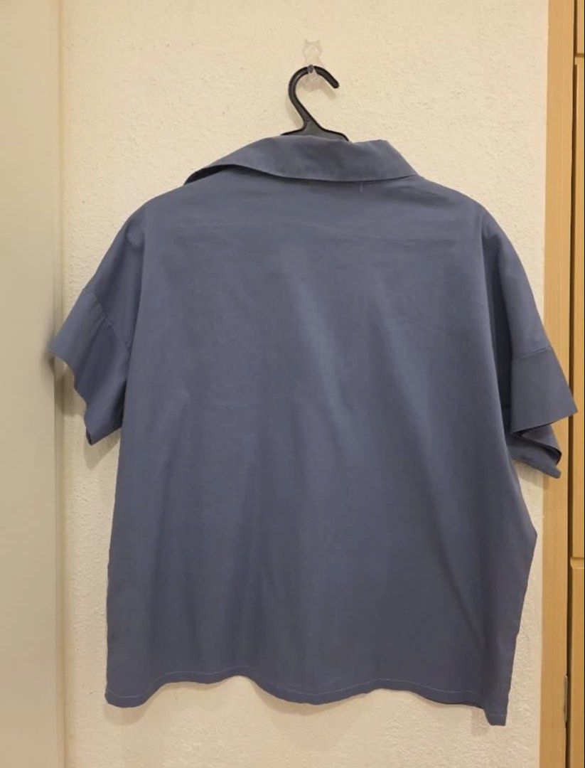Mosaic Blue Gray Short Sleeve Collared Shirt (Category: Blouses) located in Quezon City. Submitted by manggaedok (Listing ID 1460209129, Image 2). Description: - Brand: Mosaic - Color: Blue - Style: Short sleeve collared shirt - Neckline: V-cut detail - Fit: Relaxed fit - Occasion: Casual wear, versatile styling - Care Instructions: Hand wash cold, dry flat - Additional: Photos show back view and care label.