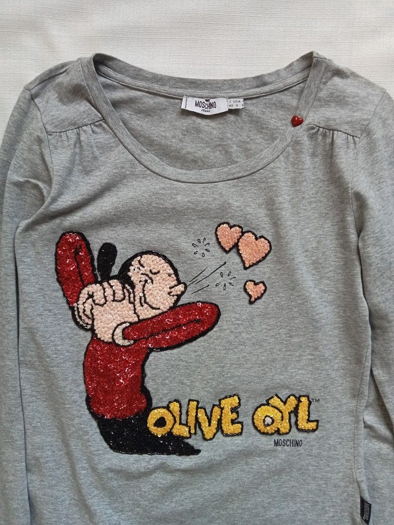 Moschino olive oyl sequin long sleeve (Category: Longsleeves) located in Bagabag. Submitted by thrift_stories96 (Listing ID 1460272884, Image 2). Description: Moschino olive oyl sequin long sleeve Medium Length - 23 Width - 17 stretch up to 18 Condition - excellent No flaw.
