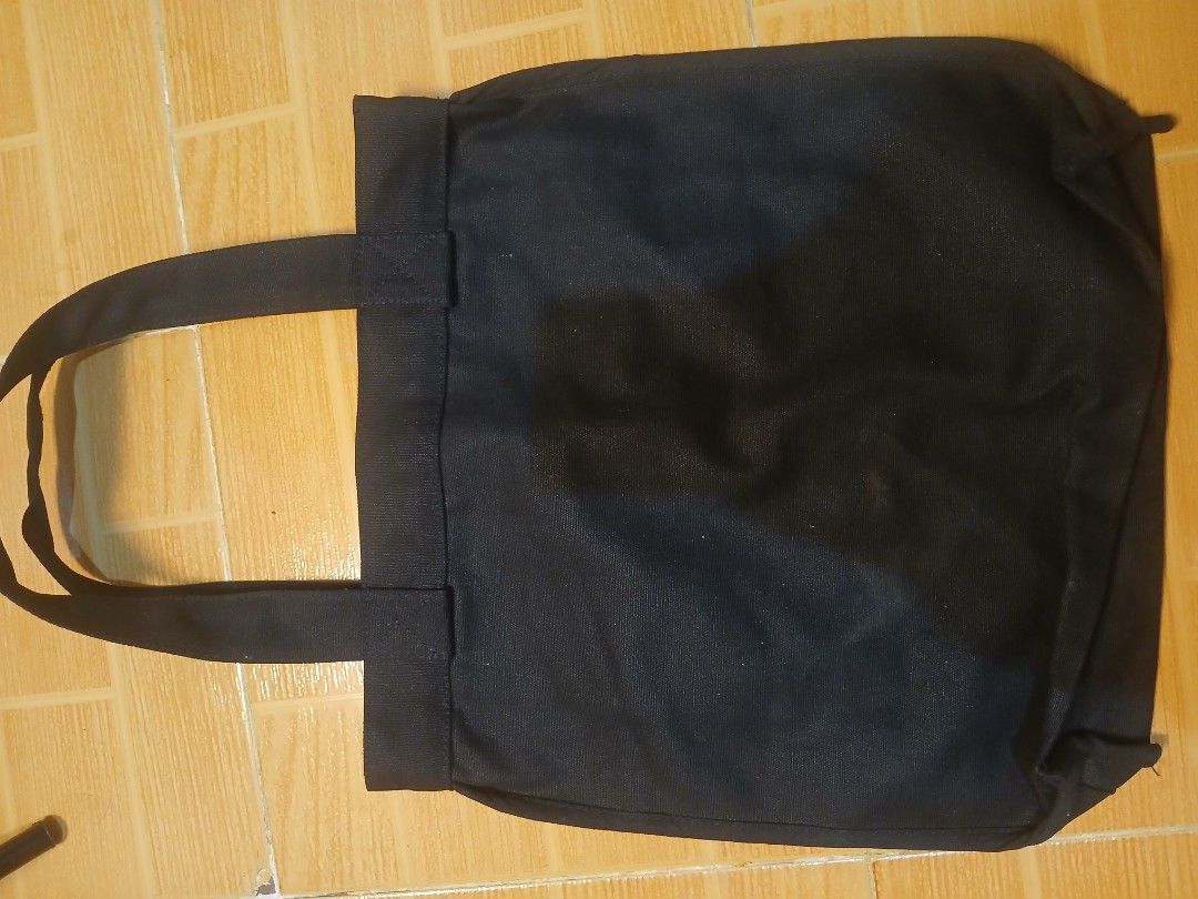 MUJI Black Canvas Tote Bag with Front Pocket (Category: Tote Bags) located in Manila. Submitted by asianwave189184 (Listing ID 1460243713, Image 2). Description: - Simple black canvas tote bag from MUJI - Convenient front pocket - Made in India - Ideal for everyday use - Approximately 14 inches wide - Durable material.