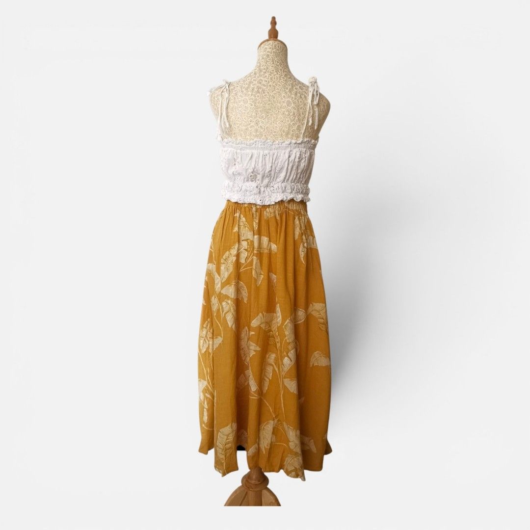 Mustard Leaf Print Midi Skirt (Category: Skirts) located in Mandaue City. Submitted by stylefigjam (Listing ID 1460237634, Image 3). Description: - Mustard yellow midi skirt with bold leaf print - Skirt features a tie waist - Garterized waistline - Ideal for beach vacations or summer outings *top not included.