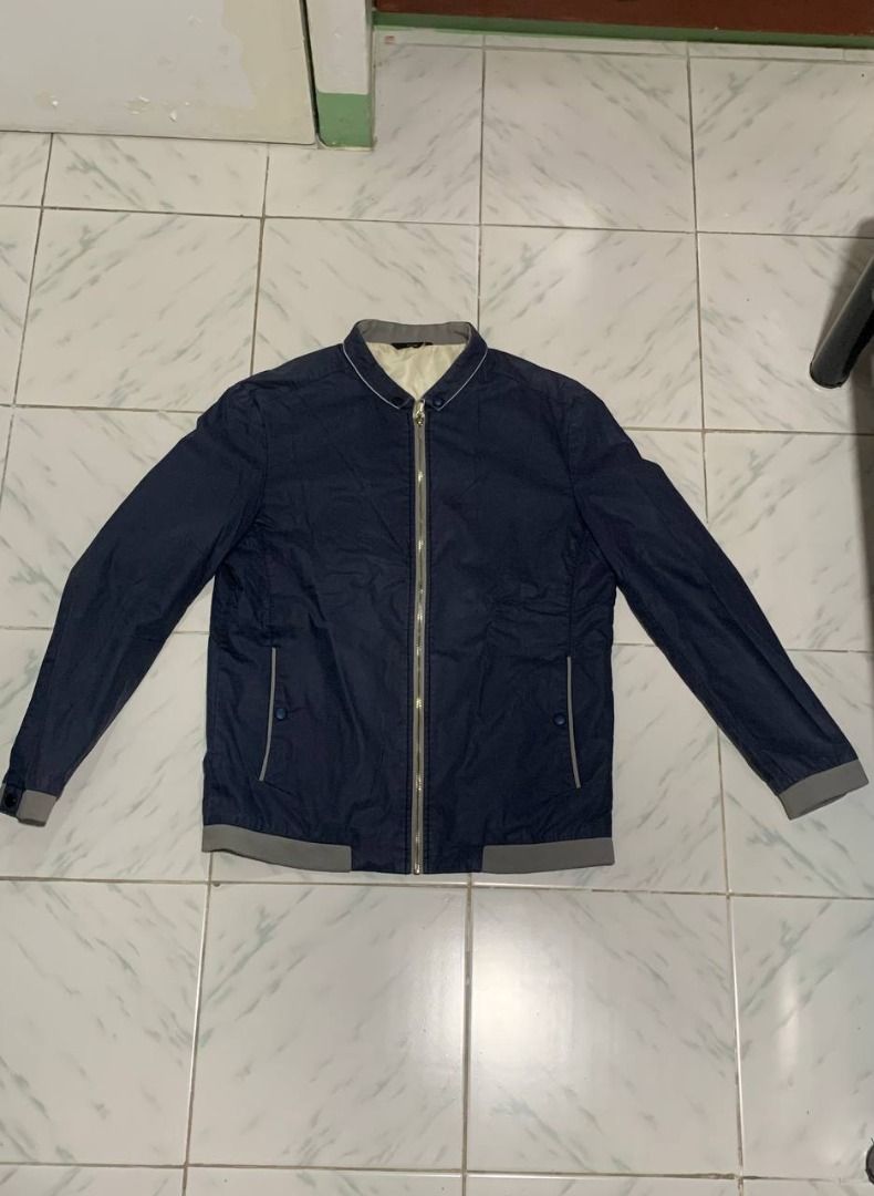 Navy Blue Bomber Jacket with Grey Accents (Category: Coats, Jackets and Outerwear) located in Marikina City. Submitted by cosmicfish_aad03c (Listing ID 1460147860, Image 1). Description: Navy blue bomber jacket with grey ribbed details. Features zip-up front and two button pockets. Lightweight and perfect for layering. L - 25 W - 18.