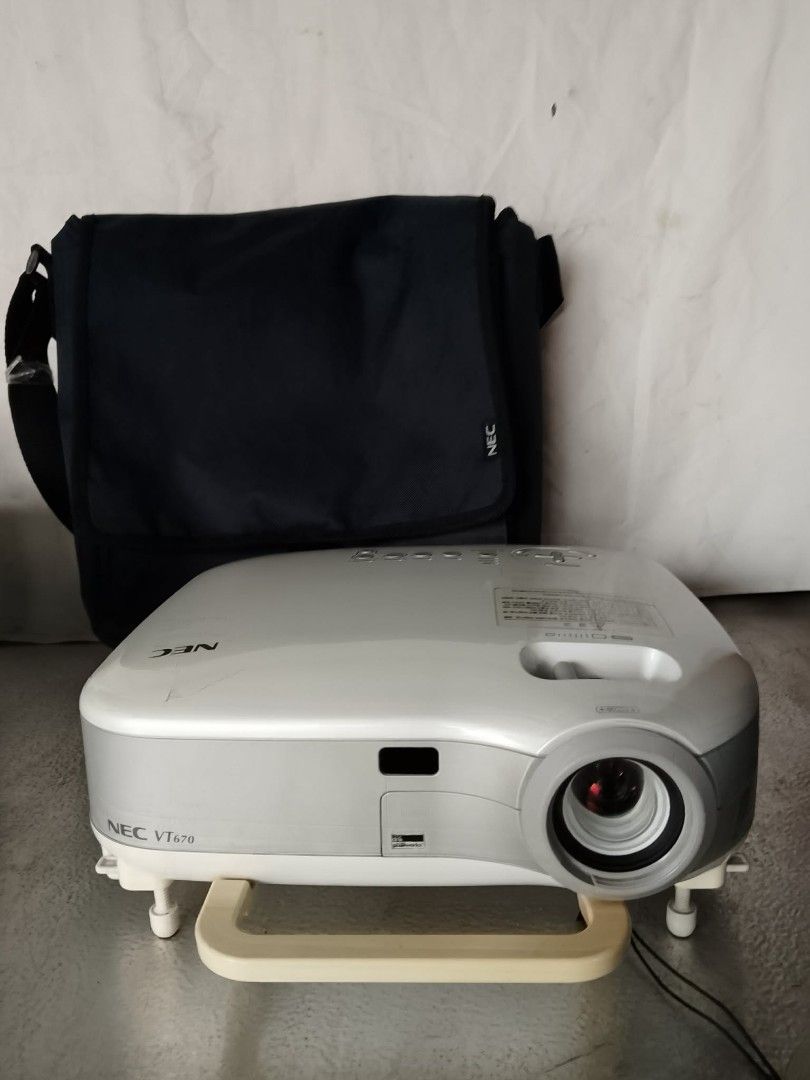 NEC VT670 Projector with Bag (Category: Projectors) located in Quezon City. Submitted by jpnvintageonline (Listing ID 1460268722, Image 3). Description: - NEC VT670 projector - Includes dark grey NEC carrying bag - Multiple input ports: S-Video, Audio, Video, Computer 1, Computer 2, Monitor Out, PC Control - Power switch and AC in located on the back - Ideal for presentations and home entertainment.