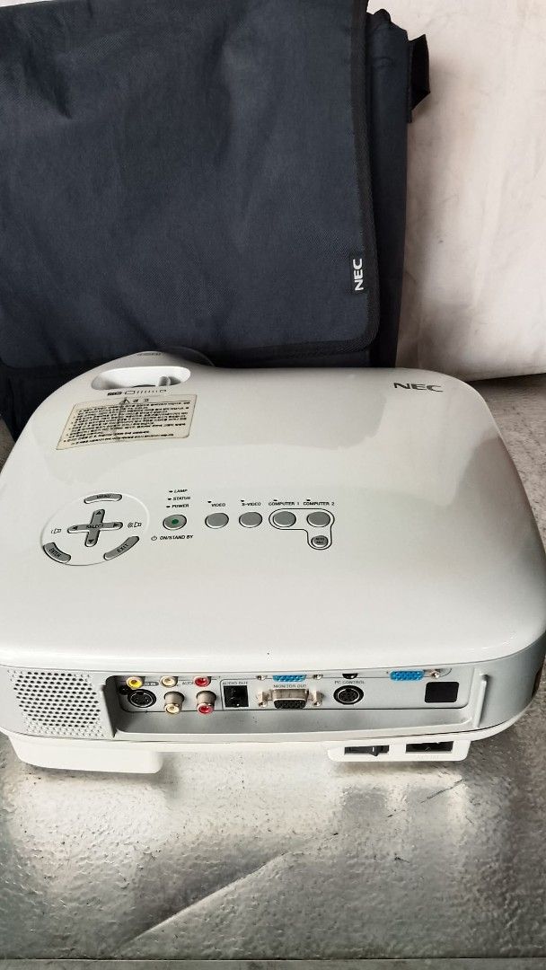 NEC VT670 Projector with Bag (Category: Projectors) located in Quezon City. Submitted by jpnvintageonline (Listing ID 1460268722, Image 2). Description: - NEC VT670 projector - Includes dark grey NEC carrying bag - Multiple input ports: S-Video, Audio, Video, Computer 1, Computer 2, Monitor Out, PC Control - Power switch and AC in located on the back - Ideal for presentations and home entertainment.