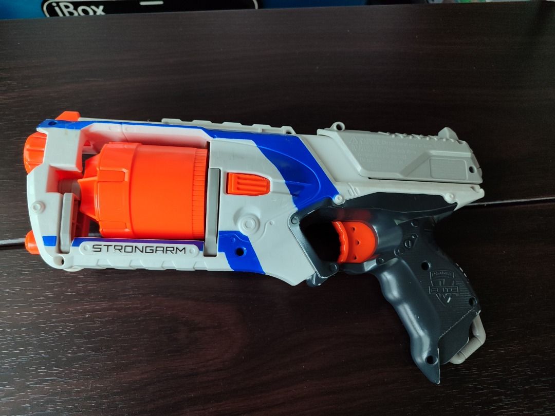 Original Nerf Elite Strongarm Blaster Toy Gun (Category: Action & Battle Toys) located in Mandaluyong City. Submitted by thethrifthaul (Listing ID 1460183731, Image 3). Description: - Nerf Elite Strongarm blaster--priming & firing - Color: White, blue, and orange - Features a 6 dart rotating barrel - no darts included - Ideal for fun and games - Ready for action!.