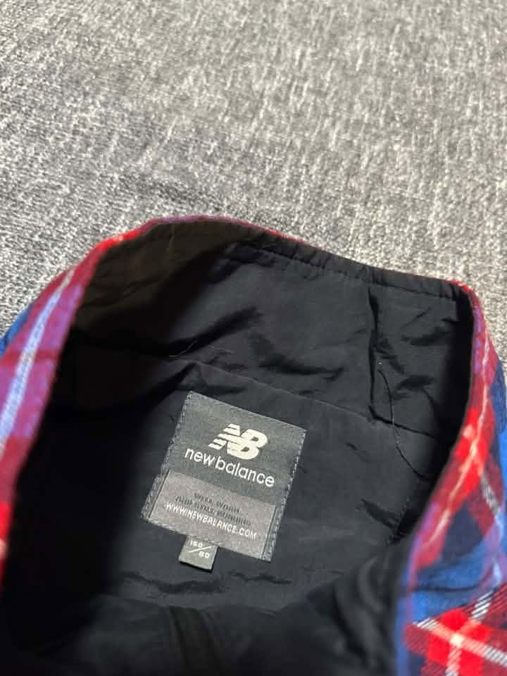 New Balance windbreaker jacket featuring a blue plaid upper (Category: Coats, Jackets and Outerwear) located in Manila. Submitted by thriftedbykab (Listing ID 1460297674, Image 3). Description: ⚙️Size : Medium 💎Condition: 10/10 🚨Color Rate: 10/10 🧨Issue: No ₱350.