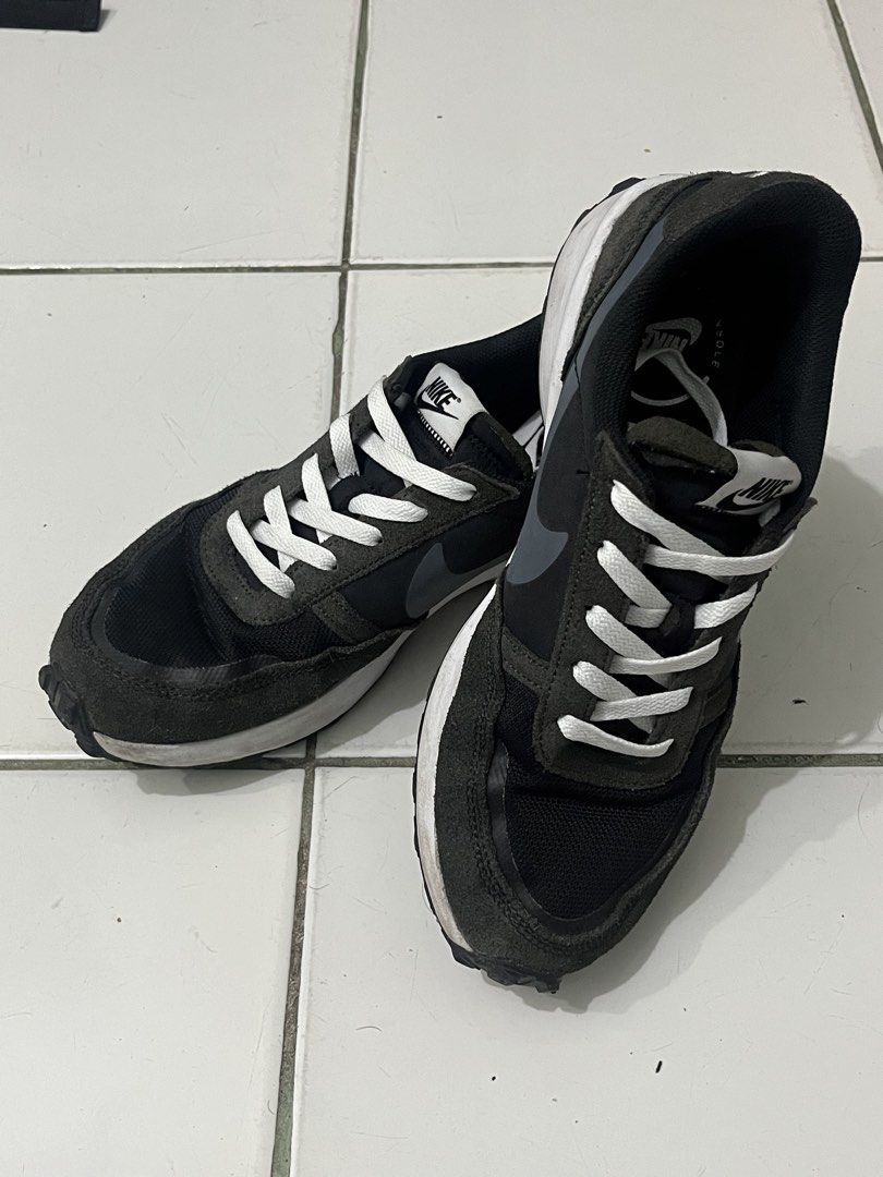 Nike Black and Grey Running Sneakers (Category: Sneakers) located in Manila. Submitted by kayd86043 (Listing ID 1460292726, Image 2). Description: - Pre-loved Nike sneakers - Color: Black and Grey - Style: Lace-up with white laces - Features: Classic Nike swoosh on the side - Ideal for: Casual wear or light jogging - Condition: Shows some signs of wear on soles and uppers.
