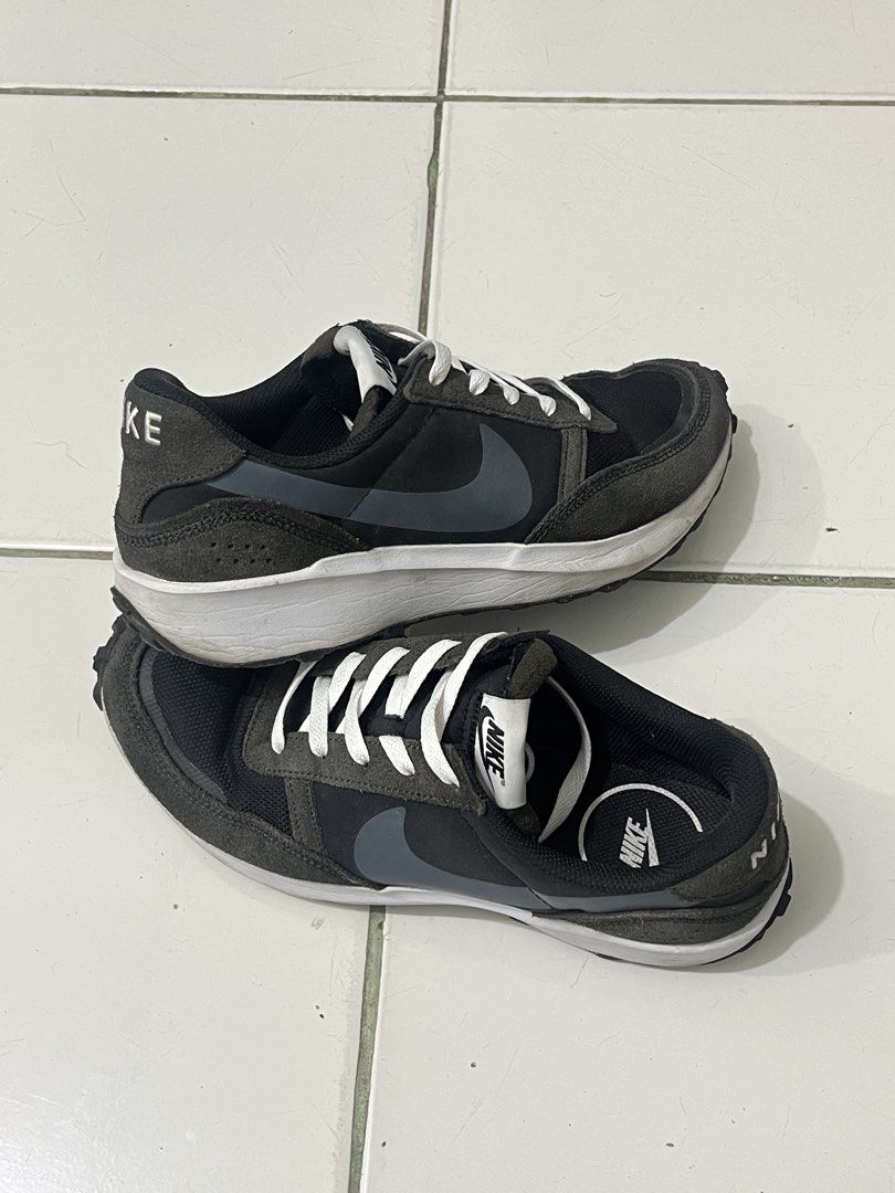 Nike Black and Grey Running Sneakers (Category: Sneakers) located in Manila. Submitted by kayd86043 (Listing ID 1460292726, Image 1). Description: - Pre-loved Nike sneakers - Color: Black and Grey - Style: Lace-up with white laces - Features: Classic Nike swoosh on the side - Ideal for: Casual wear or light jogging - Condition: Shows some signs of wear on soles and uppers.