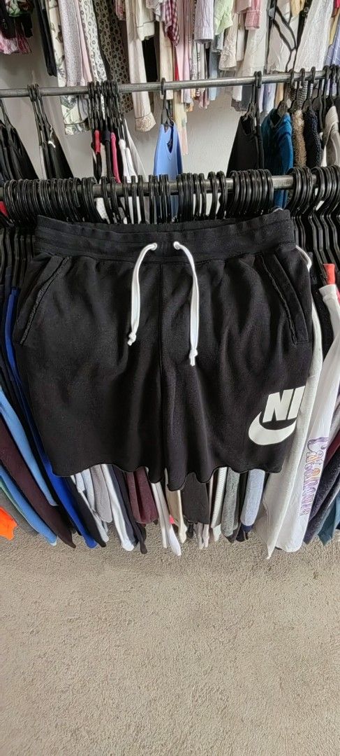 Nike Black Sweat Shorts with White Logo (Category: Shorts) located in Caloocan City. Submitted by dilenb (Listing ID 1460199221, Image 3). Description: - Black Nike sweat shorts - Classic white Nike swoosh logo on the side - Elastic waistband with white drawstring - Features pockets - Made in Thailand - Ideal for lounging or casual wear.