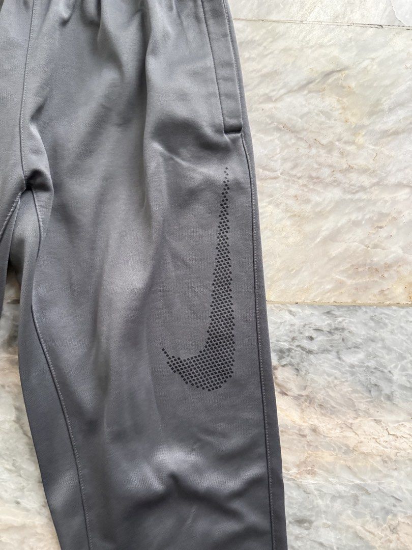 Nike Dri-Fit Grey Athletic Jogger Pants Size M (Category: Joggers) located in San Mateo. Submitted by aifoslvdr (Listing ID 1460142639, Image 2). Description: - Grey Nike Dri-Fit joggers - Elastic waistband with drawstring - Zippered pocket on left thigh - Nike logo on right leg - Size: Medium - Ideal for workouts and casual wear.