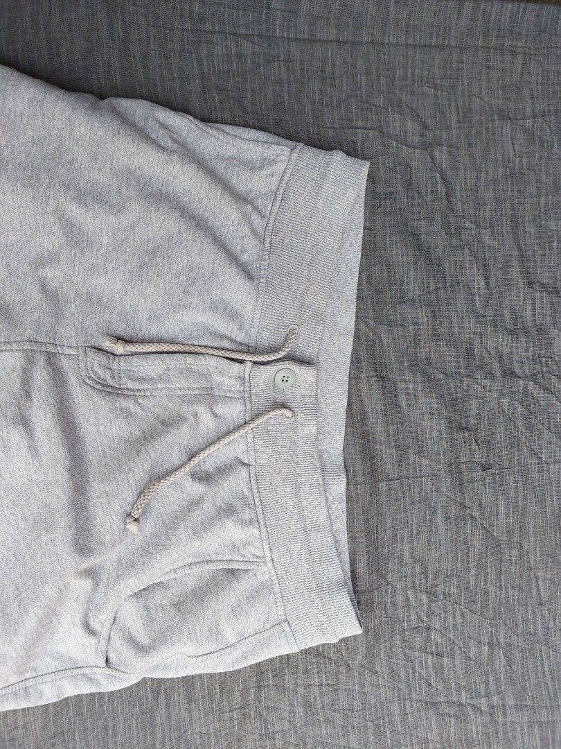 Nike Grey Sweat Shorts Size XL (Category: Shorts) located in Banga. Submitted by jahroldpan64406 (Listing ID 1460209699, Image 3). Description: - Grey Nike sweat shorts - Size XL - Elastic waistband with drawstring and button closure - Two side pockets - Small Nike logo on left leg - Ideal for lounging or light workouts.