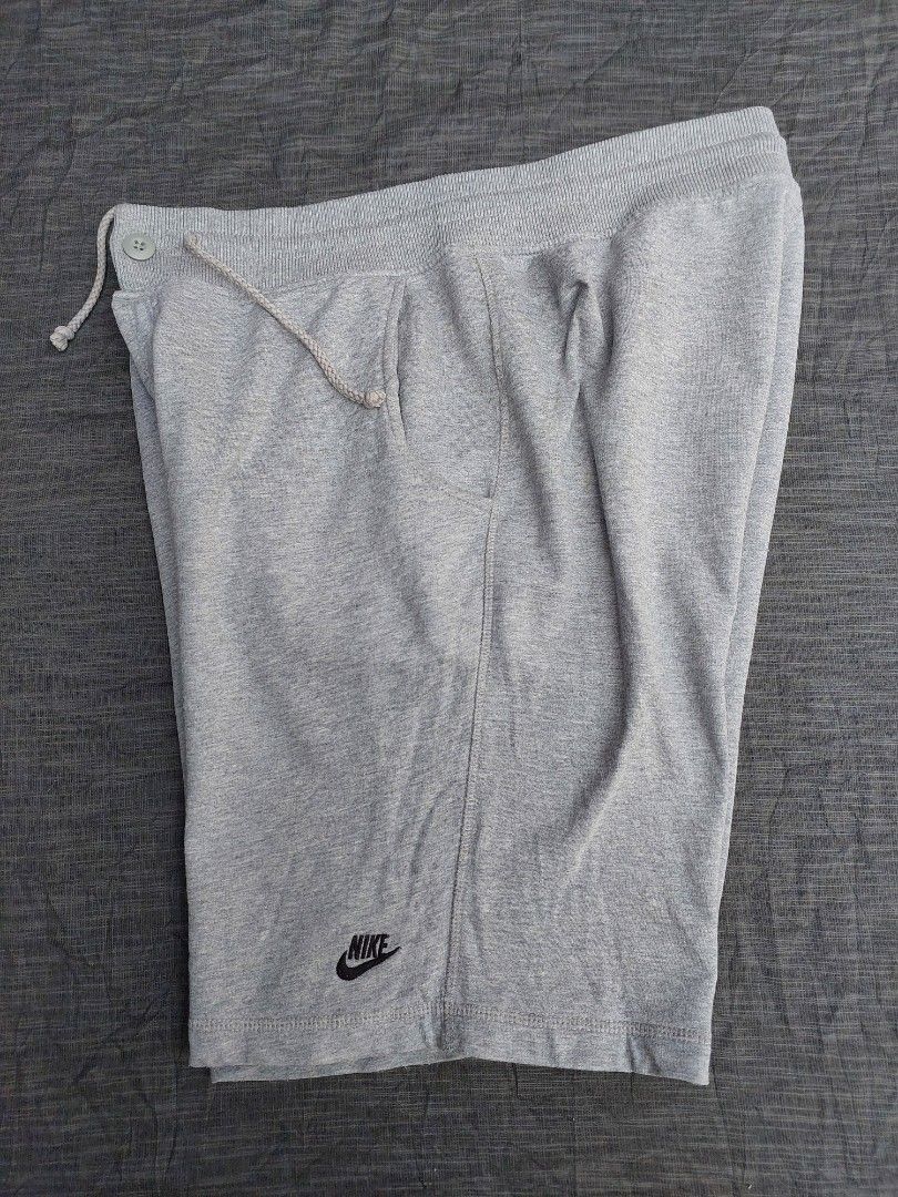 Nike Grey Sweat Shorts Size XL (Category: Shorts) located in Banga. Submitted by jahroldpan64406 (Listing ID 1460209699, Image 2). Description: - Grey Nike sweat shorts - Size XL - Elastic waistband with drawstring and button closure - Two side pockets - Small Nike logo on left leg - Ideal for lounging or light workouts.