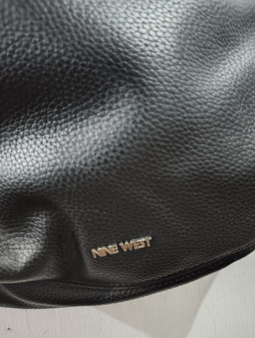 Nine West Black Leather Hobo Shoulder Bag (Category: Shoulder Bags) located in Manila. Submitted by marjdv29 (Listing ID 1460204304, Image 2). Description: - Black Nine West hobo bag - Textured leather material - Magnetic snap closure - Multiple interior compartments - Interior zippered pocket - Comfortable shoulder strap - Ideal for everyday essentials - Clean inside and out.