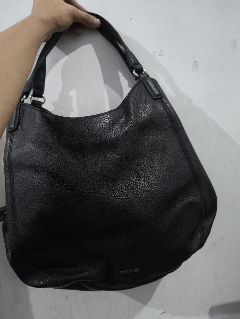 Nine West Black Leather Hobo Shoulder Bag (Category: Shoulder Bags) located in Manila. Submitted by marjdv29 (Listing ID 1460204304, Image 1). Description: - Black Nine West hobo bag - Textured leather material - Magnetic snap closure - Multiple interior compartments - Interior zippered pocket - Comfortable shoulder strap - Ideal for everyday essentials - Clean inside and out.