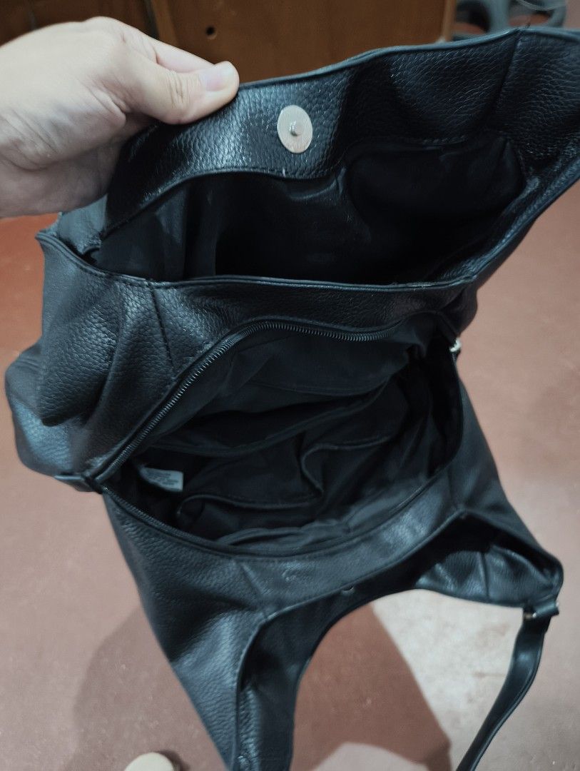 Nine West Black Leather Hobo Shoulder Bag (Category: Shoulder Bags) located in Manila. Submitted by marjdv29 (Listing ID 1460204304, Image 3). Description: - Black Nine West hobo bag - Textured leather material - Magnetic snap closure - Multiple interior compartments - Interior zippered pocket - Comfortable shoulder strap - Ideal for everyday essentials - Clean inside and out.
