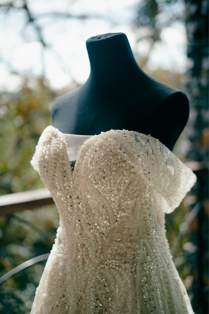 Off-Shoulder Full Beaded Wedding Gown with Long Train (Category: Evening dresses & gowns) located in Marikina City. Submitted by jaijao (Listing ID 1460156258, Image 1). Description: - Custom 3-way fully beaded gown - Beautiful off-shoulder wedding dress - removable sleeves - Intricate beading and sequins on bodice and skirt - 2-meter Dramatic long train for a grand entrance - Includes matching veil - Worn only once for a wedding ceremony - Ready
