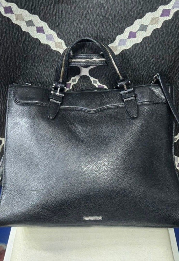 OG Rebecca Minkoff Black Leather Bag (Category: Luxury Bags & Wallets) located in Manila. Submitted by affordabags_cd (Listing ID 1460227671, Image 2). Description: - Genuine black leather tote bag by Rebecca Minkoff - Versatile carrying options: top handles and detachable crossbody strap - Secure zipper closure for your belongings - Chic fringe detailing on the sides - Spacious interior, ideal for everyday essentials.