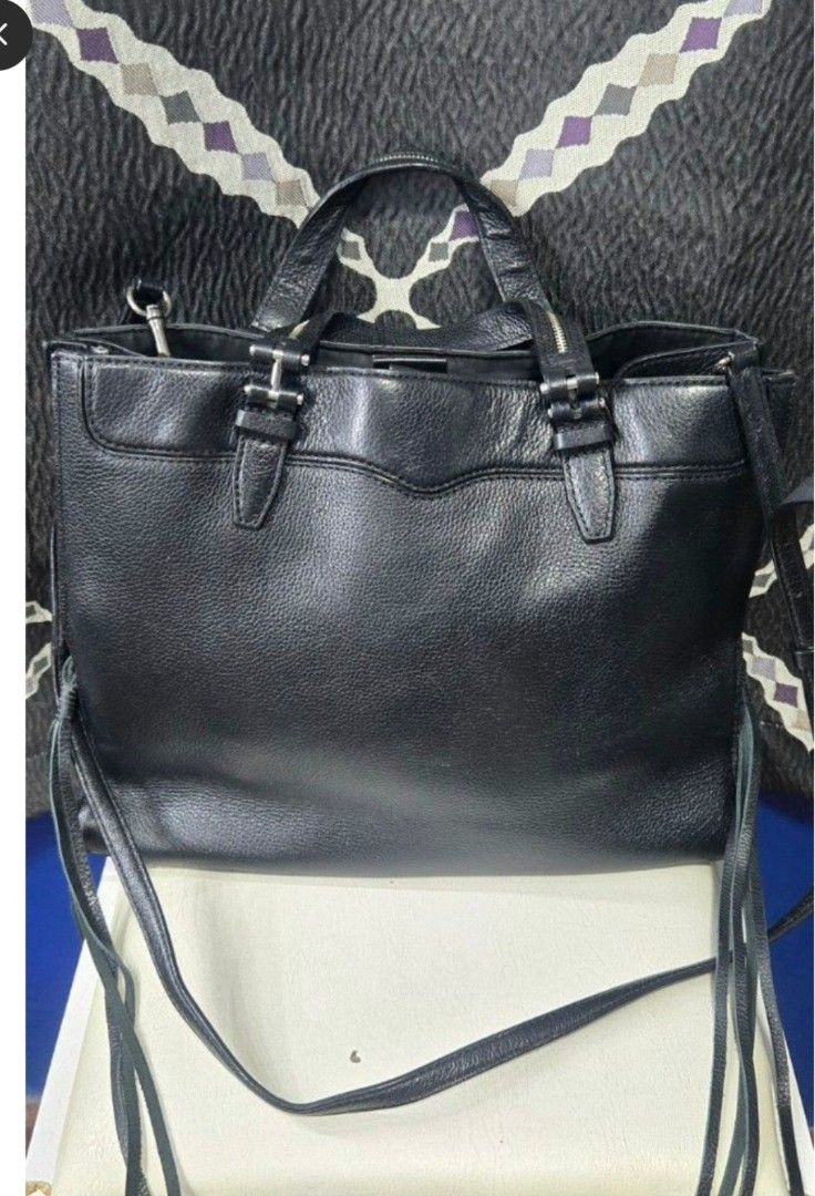OG Rebecca Minkoff Black Leather Bag (Category: Luxury Bags & Wallets) located in Manila. Submitted by affordabags_cd (Listing ID 1460227671, Image 1). Description: - Genuine black leather tote bag by Rebecca Minkoff - Versatile carrying options: top handles and detachable crossbody strap - Secure zipper closure for your belongings - Chic fringe detailing on the sides - Spacious interior, ideal for everyday essentials.