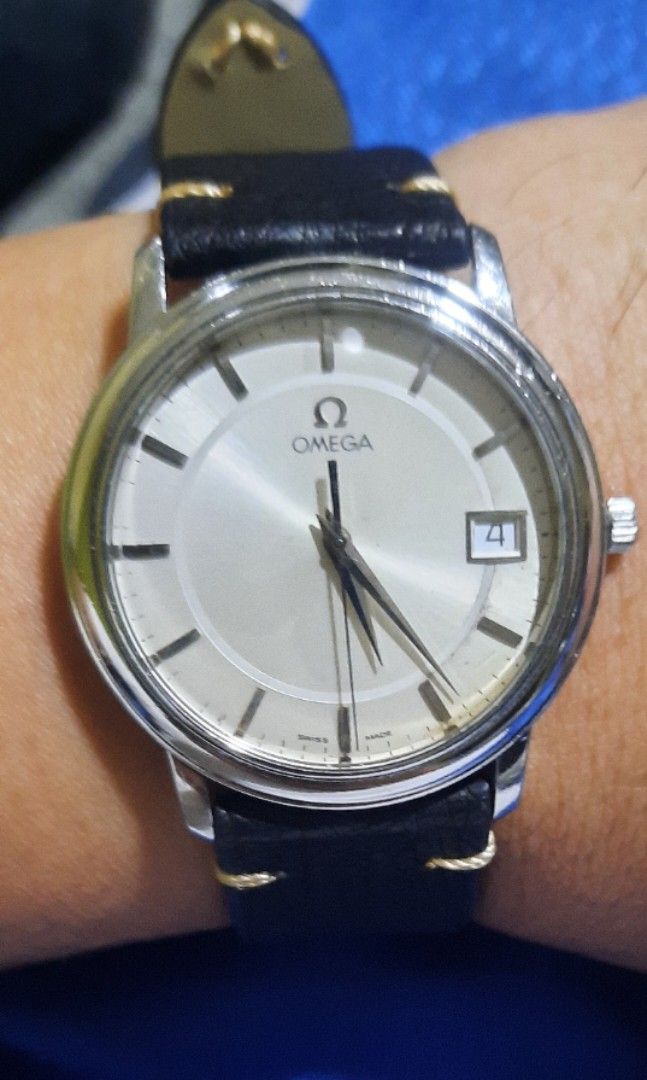 Omega de ville prestige (Category: Luxury Watches) located in Bulacan. Submitted by ricoalba0697261 (Listing ID 1457928781, Image 2). Description: - Authentic Omega watch - Classic silver dial with date window at 3 o'clock. sapphire crystal 34mm case - Features a vibrant red leather strap - Secured with an Omega logo buckle - Watch case shows some signs of wear, consistent with normal use - Please refer to the provided photos for detailed conditi