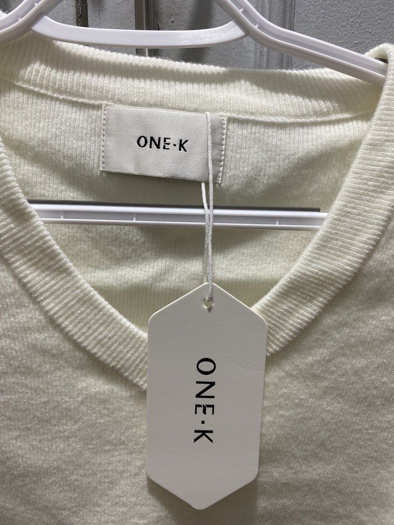 ONE-K White V-Neck Knit Top (Category: Blouses) located in Manila. Submitted by glads_closet (Listing ID 1460192706, Image 1). Description: White knit top from ONE-K. Short sleeves with a V-neckline. Simple and classic design. Easy to style with anything..
