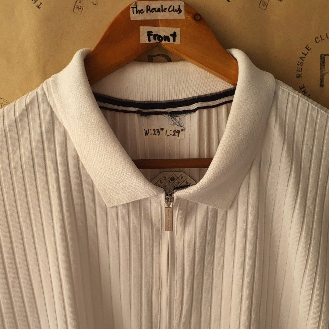 Perry Ellis White Ribbed Zip Polo Shirt (Category: Tshirts & Polo Shirts ) located in Tarlac. Submitted by resaleclub (Listing ID 1460124574, Image 2). Description: - White short-sleeve polo shirt - Features a ribbed texture all over - Zip-up neckline - Collar with subtle stripe detail - Measurements: W: 23", L: 29" - Ideal for casual wear.
