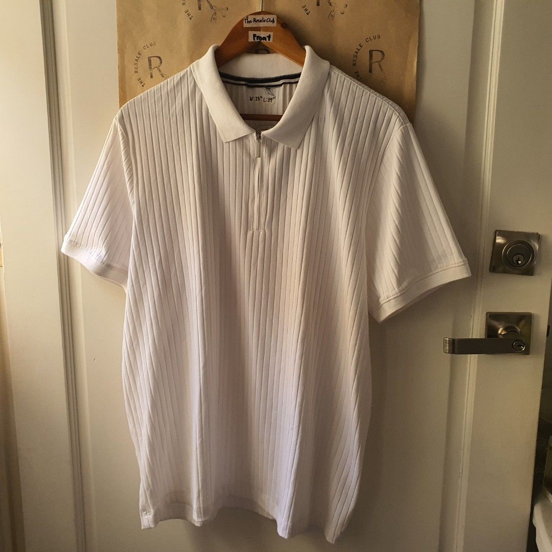 Perry Ellis White Ribbed Zip Polo Shirt (Category: Tshirts & Polo Shirts ) located in Tarlac. Submitted by resaleclub (Listing ID 1460124574, Image 1). Description: - White short-sleeve polo shirt - Features a ribbed texture all over - Zip-up neckline - Collar with subtle stripe detail - Measurements: W: 23", L: 29" - Ideal for casual wear.