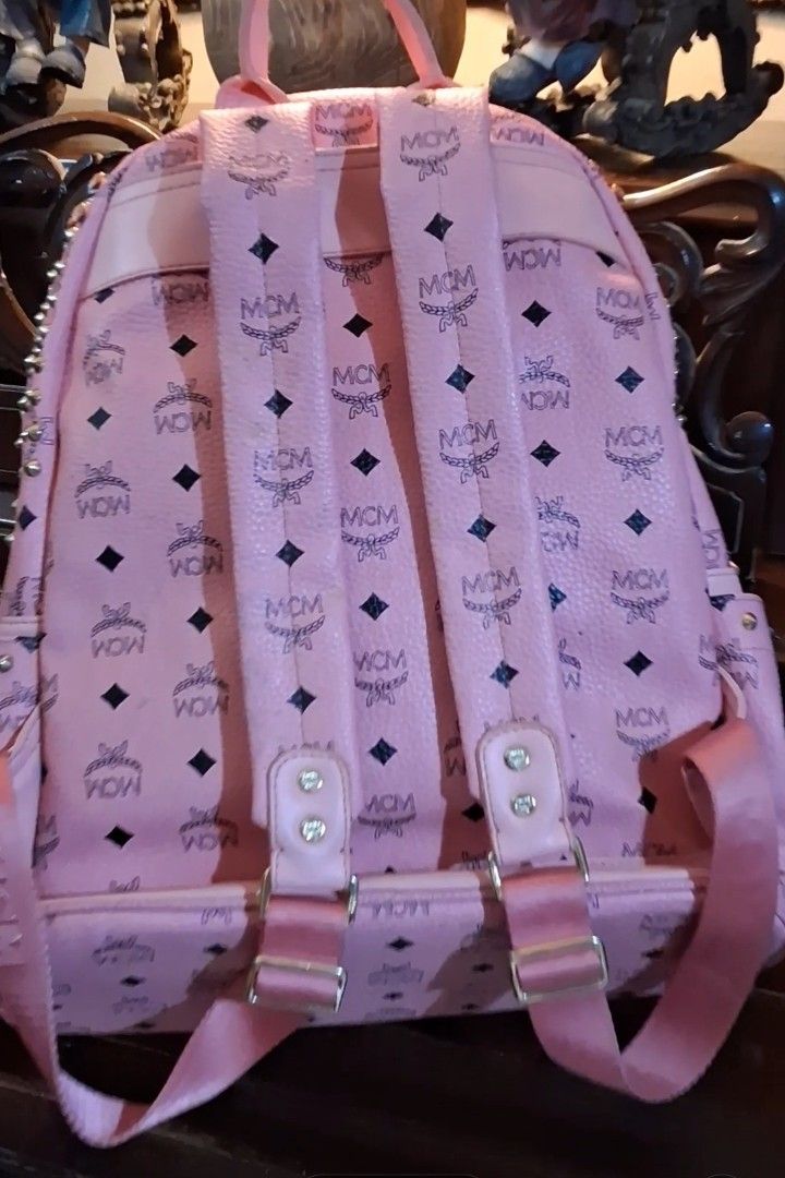Pink MCM Backpack with Monogram Print (Category: Backpacks) located in Taguig. Submitted by divine_kitty (Listing ID 1460239974, Image 1). Description: - Pink MCM backpack with signature monogram print - Features adjustable straps - Gold-tone hardware - Spacious interior for essentials - Ideal for daily use or travel.