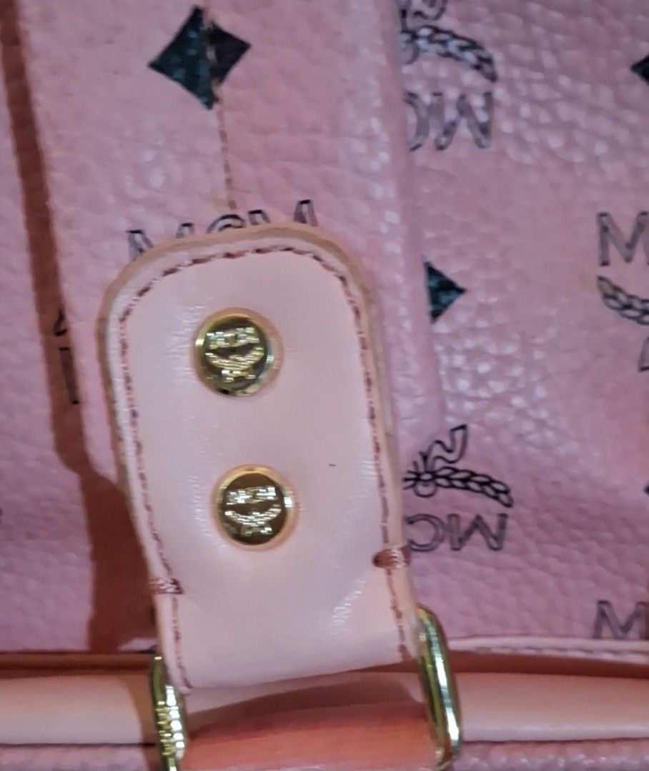 Pink MCM Backpack with Monogram Print (Category: Backpacks) located in Taguig. Submitted by divine_kitty (Listing ID 1460239974, Image 3). Description: - Pink MCM backpack with signature monogram print - Features adjustable straps - Gold-tone hardware - Spacious interior for essentials - Ideal for daily use or travel.