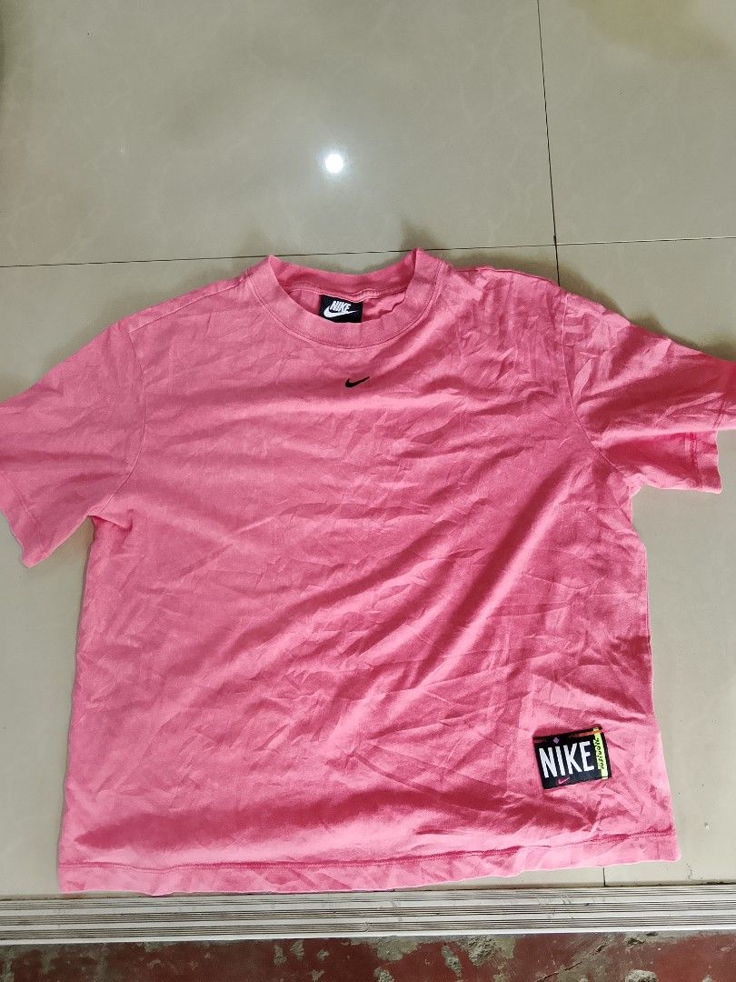 Pink Nike T-Shirt (Category: Tshirts & Polo Shirts ) located in Manila. Submitted by arjaygoodfind (Listing ID 1460108249, Image 1). Description: - Cute pink Nike t-shirt - Features a small Nike logo on the chest - Includes a Nike patch on the side - Relaxed fit for comfort - Ideal for everyday casual wear.