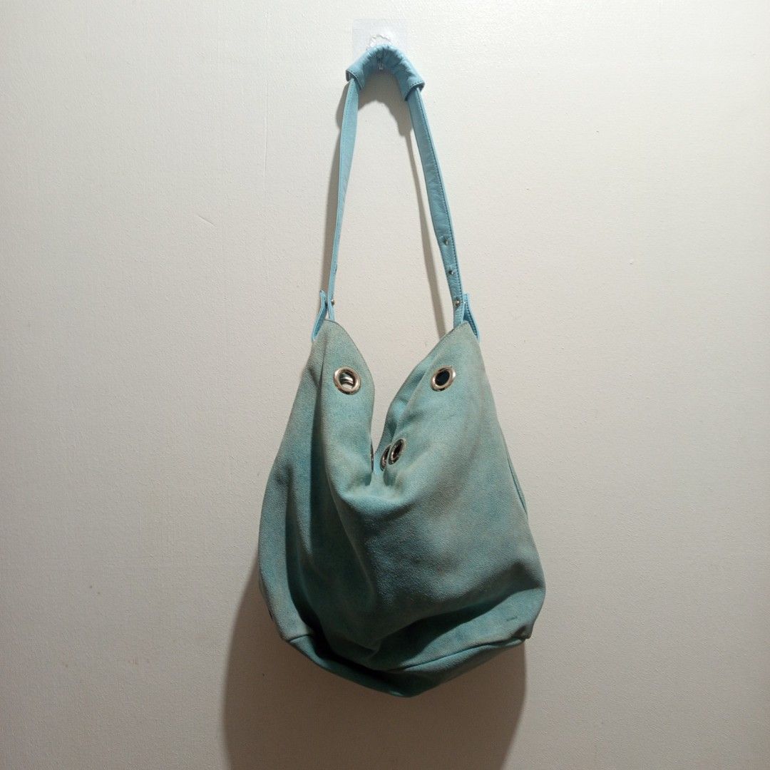 Pisaro Turquoise Hobo Bag (Category: Shoulder Bags) located in Manila. Submitted by hezzy.ph (Listing ID 1460301574, Image 1). Description: Pisaro Turquoise Hobo Bag with metal grommets suede and leather material y2k and cutesy needs polishing.