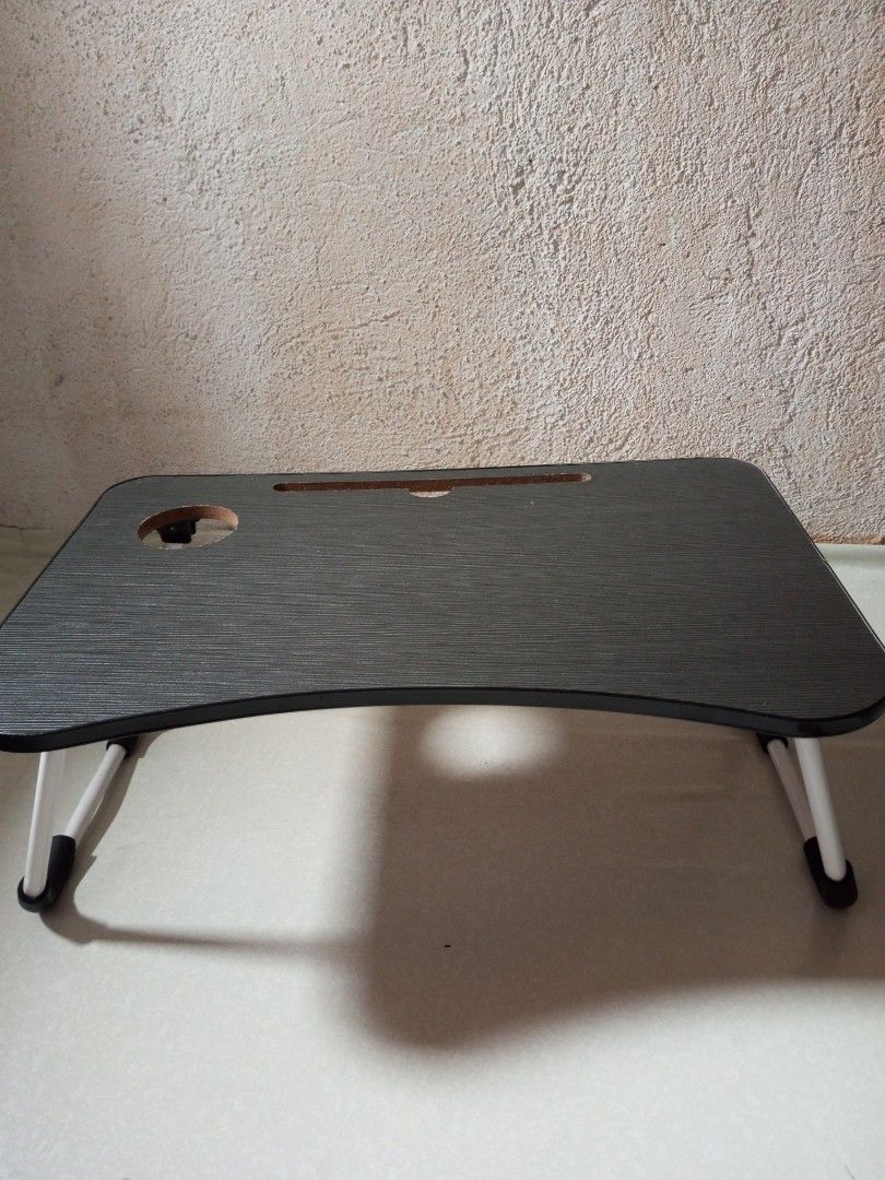 Portable Foldable Laptop Bed Table with Cup Holder (Category: Tables & Sets) located in Malolos. Submitted by radapostol (Listing ID 1460160784, Image 1). Description: - Available in black and pink - Convenient foldable table for your laptop. - Built-in cup holder and slot for tablet/phone. - Legs fold flat for easy storage. - Perfect for bed or couch use. - Stylish dark wood grain finish..