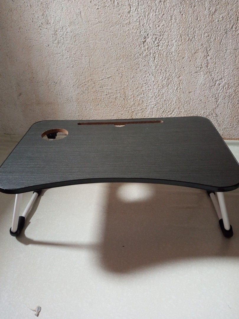 Portable Foldable Laptop Bed Table with Cup Holder (Category: Tables & Sets) located in Malolos. Submitted by radapostol (Listing ID 1460160784, Image 2). Description: - Available in black and pink - Convenient foldable table for your laptop. - Built-in cup holder and slot for tablet/phone. - Legs fold flat for easy storage. - Perfect for bed or couch use. - Stylish dark wood grain finish..