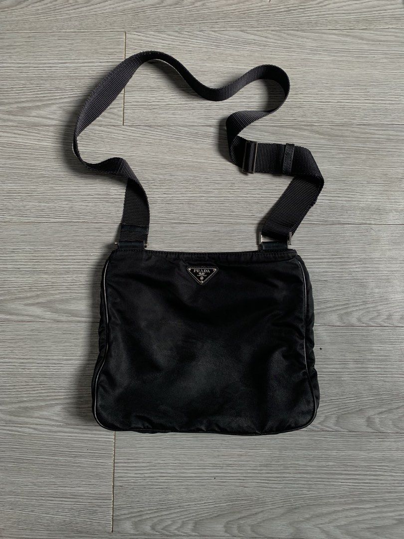 Prada Nylon Crossbody Bag (Category: Luxury Bags & Wallets) located in Pozorrubio. Submitted by plco. (Listing ID 1460113332, Image 1). Description: Prada nylon crossbody bag Width: 8.5 inches Height: 7.5 inches missing white tag broken inner zip minor scuff no other issues.