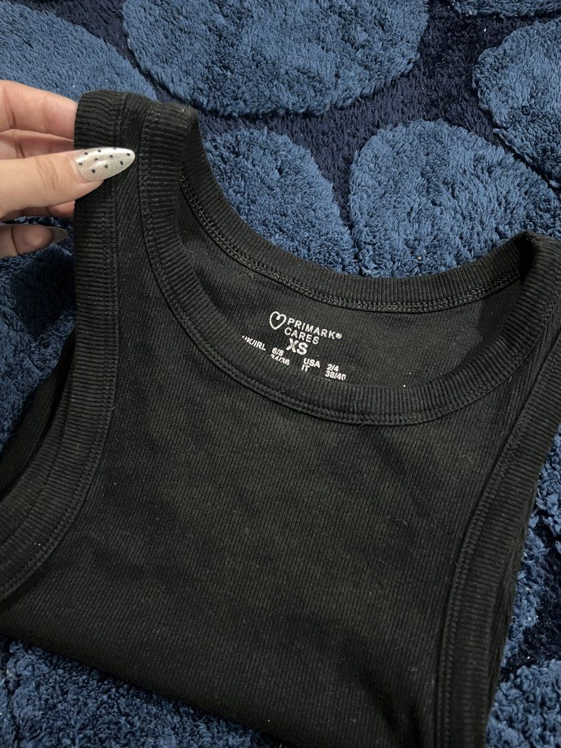 Primark Cares Black Ribbed Tank Top XS (Category: Sleeveless) located in Manila. Submitted by camieday04 (Listing ID 1460149593, Image 2). Description: - Brand: Primark Cares - Color: Black - Style: Ribbed Tank Top - Size: XS - Features: Sleeveless, Racerback cut - Material: Stretchy for comfort - Versatility: Great for layering or wearing alone.
