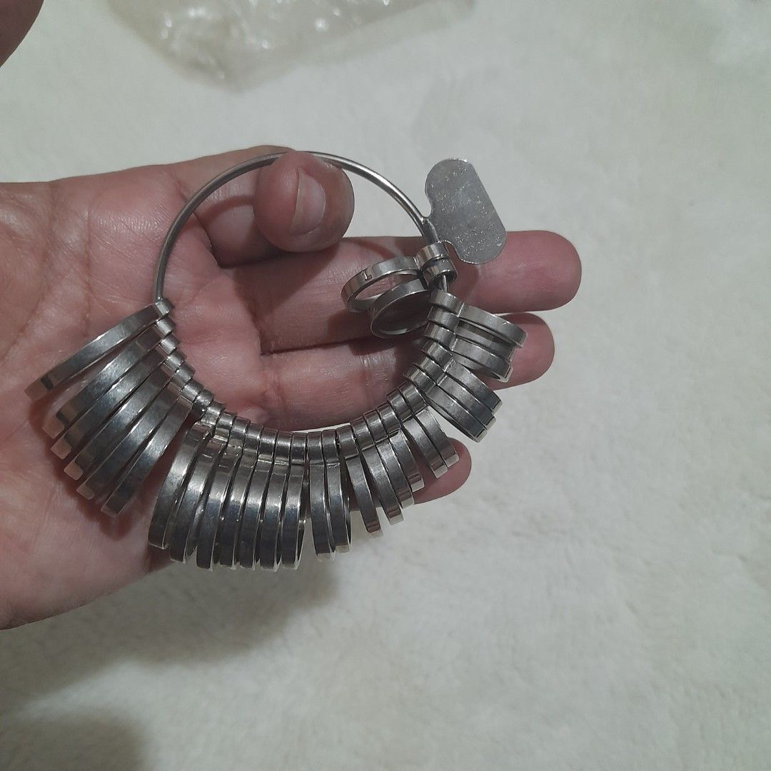 Professional Ring Sizer Gauge Set (Category: Rings) located in Bocaue. Submitted by marajapansurplus (Listing ID 1460238254, Image 3). Description: - selling as it is - set of ring sizer gauges - Durable metal construction - Includes a key for easy opening and closing - All pieces attached to a ring for organization - Ideal for jewelers or personal ring sizing needs.